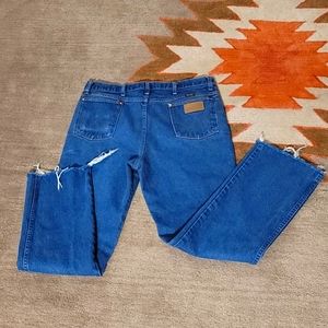 Distressed Wrangler jeans.